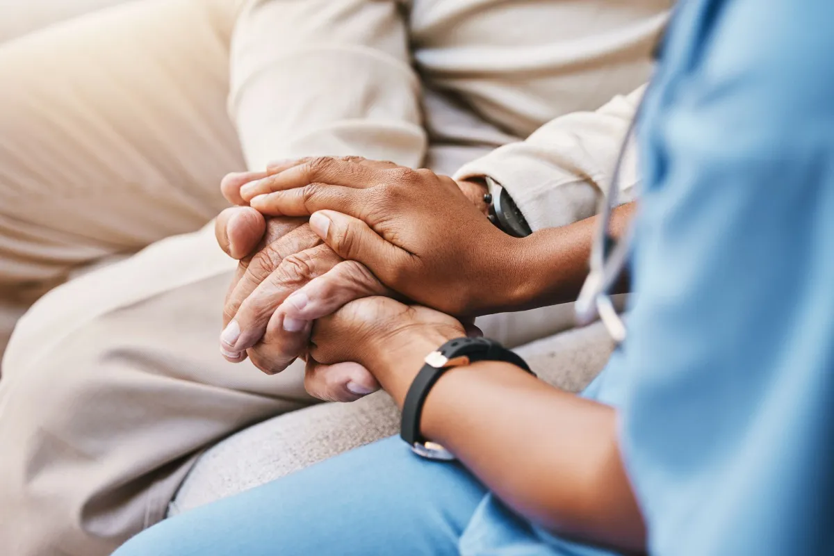 Nurse holding hands patient empathy trust