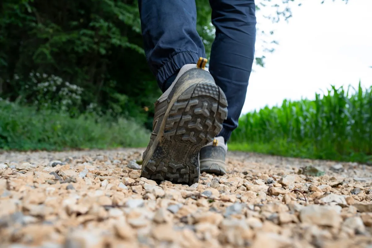 Man stepping on a rocky gravel path